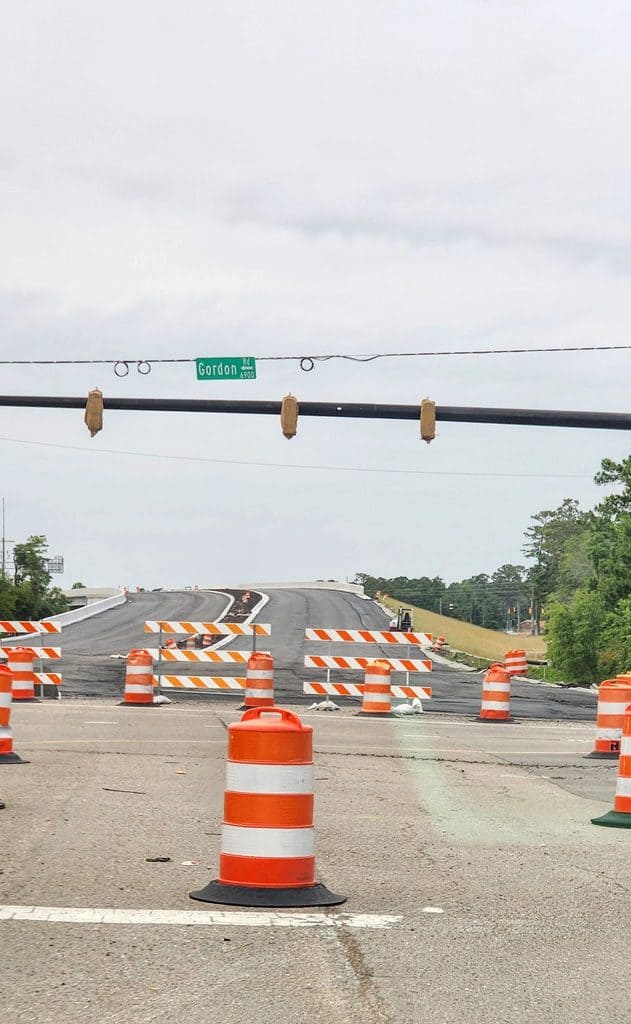Wilmington NC road projects under construction at the Gordon Road interchange, with barricades and traffic barrels on a newly paved lane