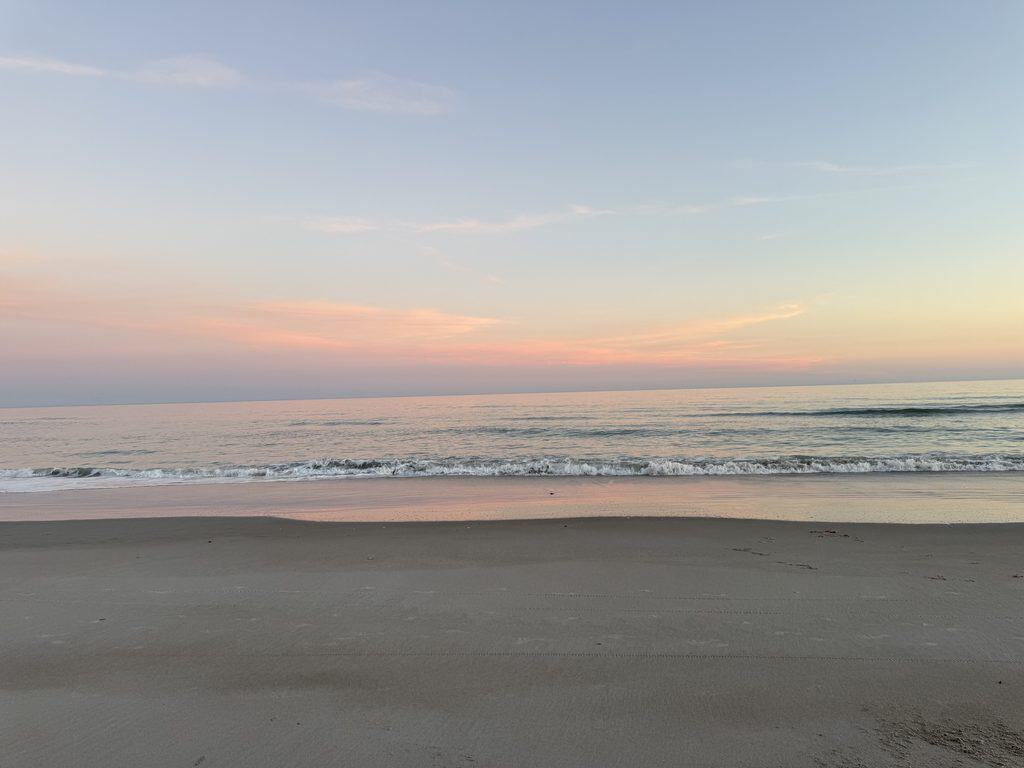Topsail Beach shoreline at sunset, one of the coastal towns worth considering when buying a home in Wilmington NC