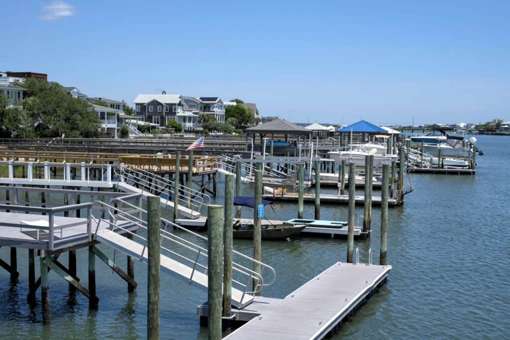 Waterfront docks with boats and houses in a coastal setting.