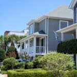 Coastal home with a well-maintained garden and blue sky in the background.
