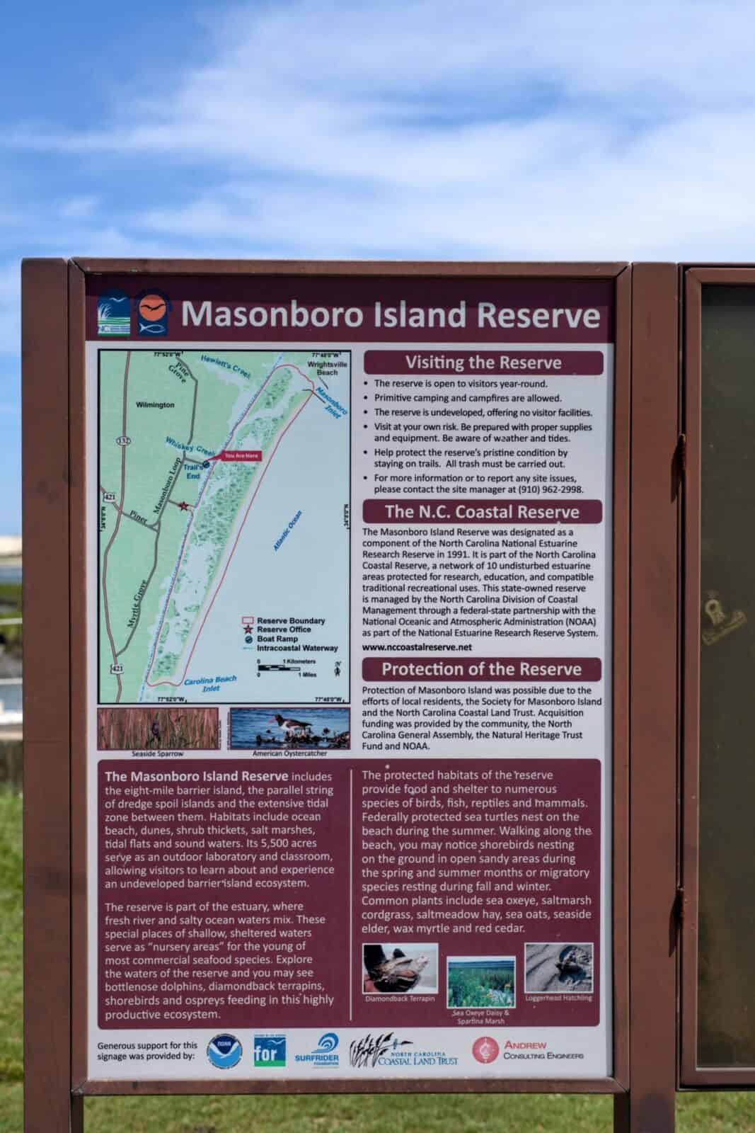 Masonboro Island Reserve information sign with a map and visitor guidelines near Wilmington, NC.