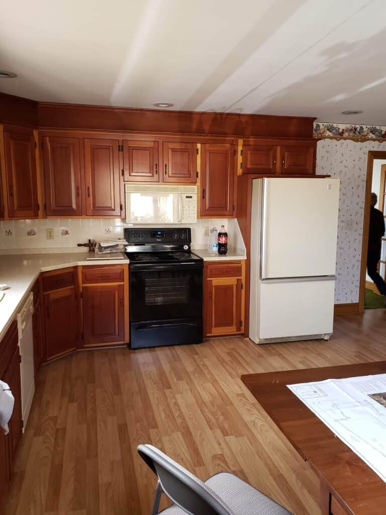 Original 1970s kitchen with cherry cabinets and white appliances
