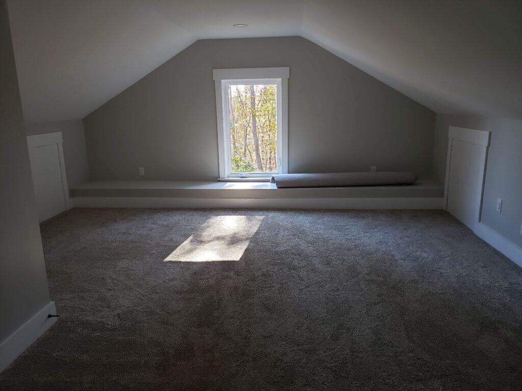 Finished attic room with window and new carpet