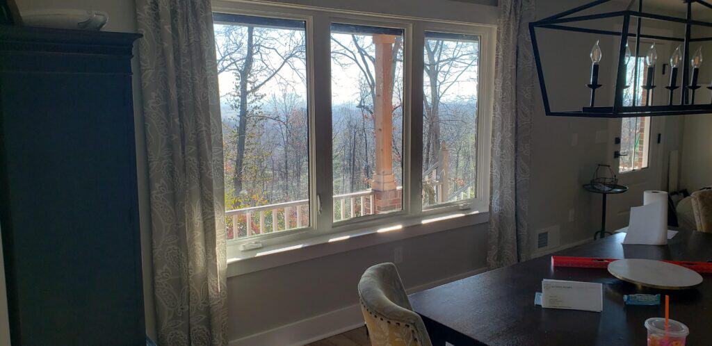 Wooded view through the renovated sunroom windows