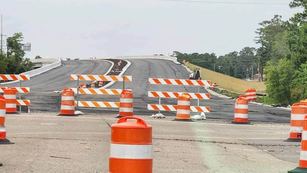 Road construction with orange barrels and barriers in Wilmington, NC.
