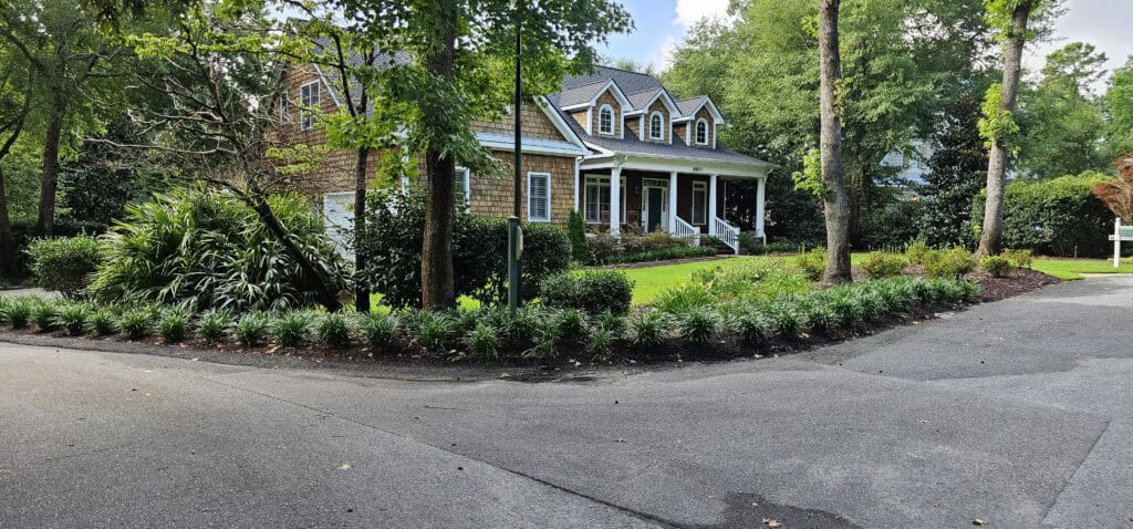 Brick home with mature trees on a quiet Wilmington NC street