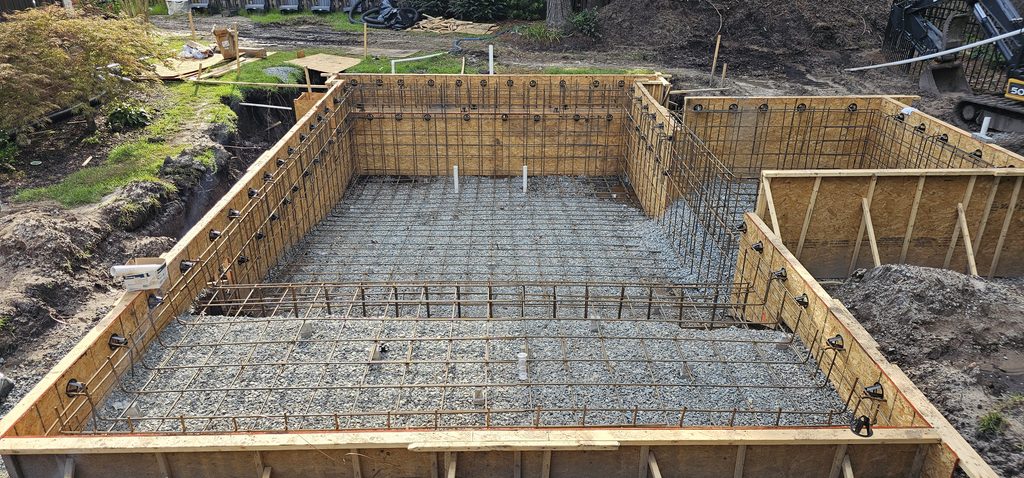 Rebar grid and wooden forms set for the gunite pool and spa