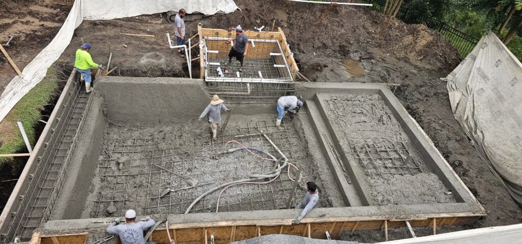 Crew shaping the gunite shell of the pool and spa