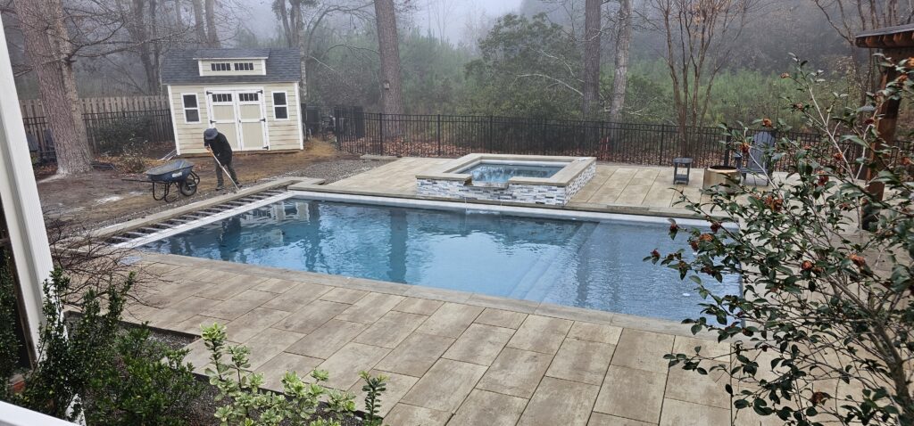 Newly filled backyard pool and spa on a misty morning