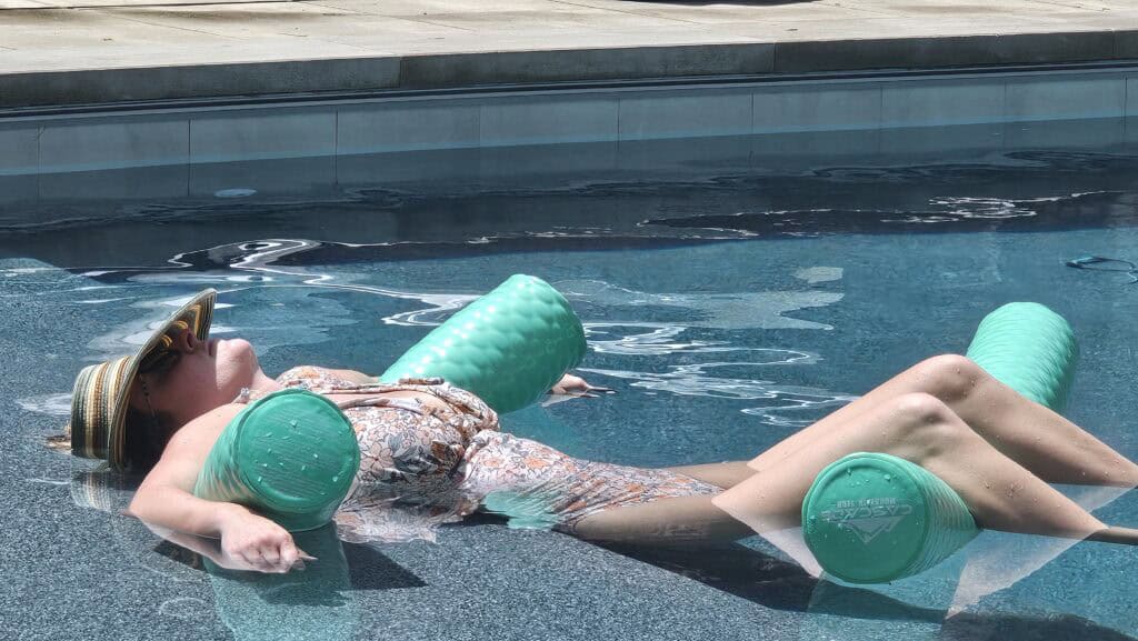 Floating on pool noodles, fully relaxed and passed out in the pool