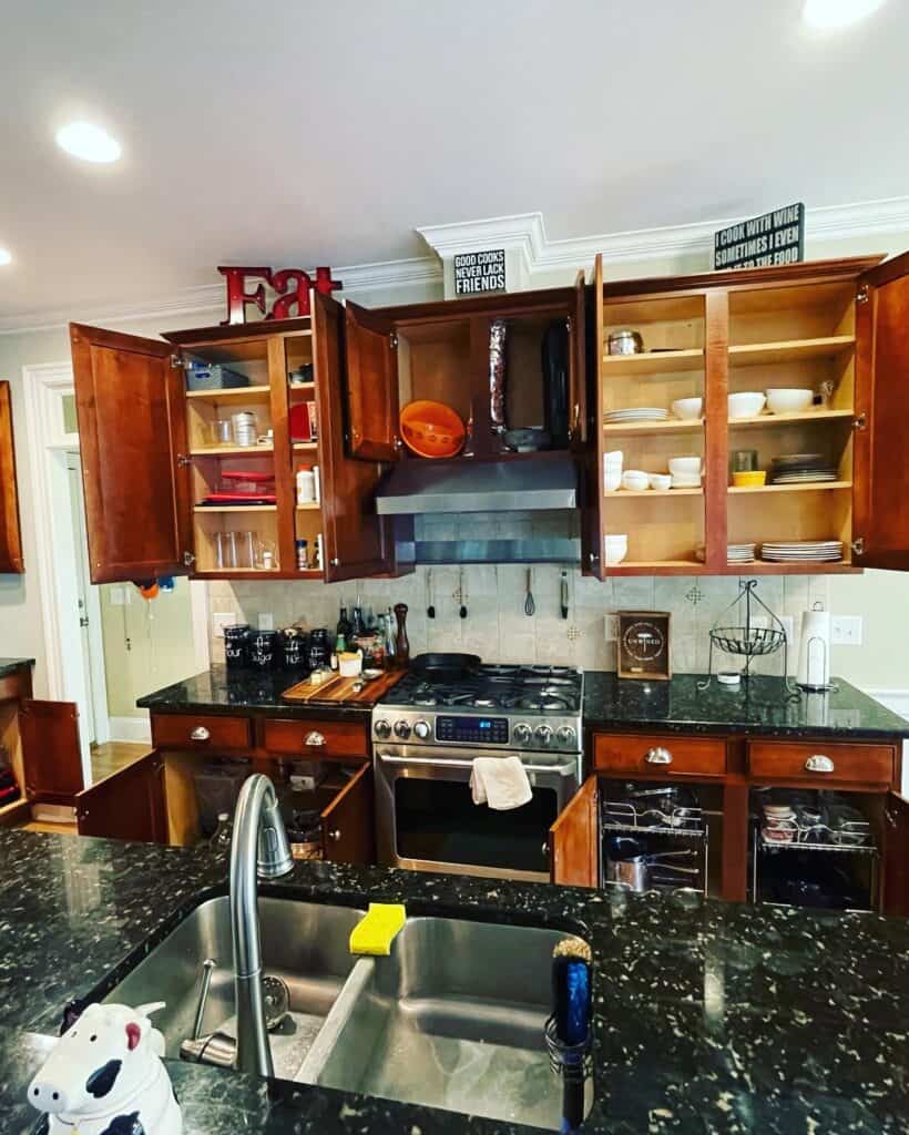 Wilmington kitchen before the remodel with cherry cabinets, glass-front uppers and almost-black granite countertops