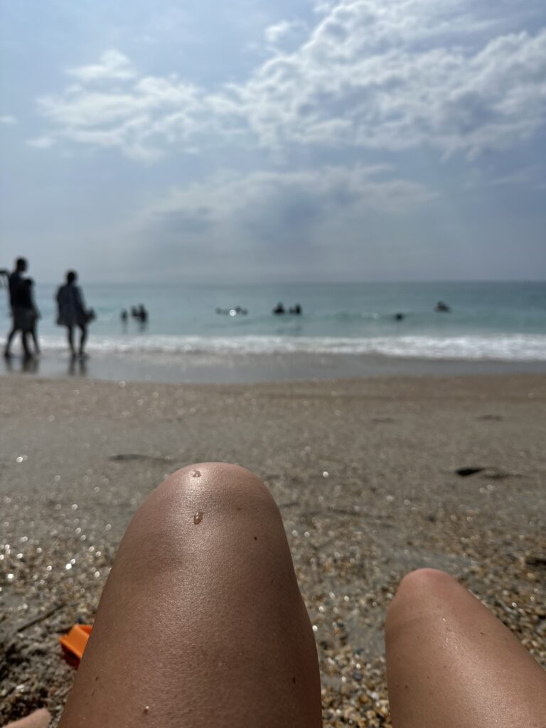 Lying on the sand at the water's edge on a beach near Wilmington NC, two hours from Raleigh