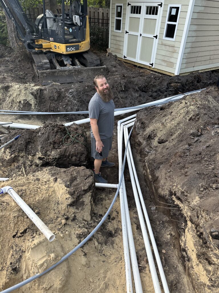 Plumbing lines running through a trench to the pool equipment area