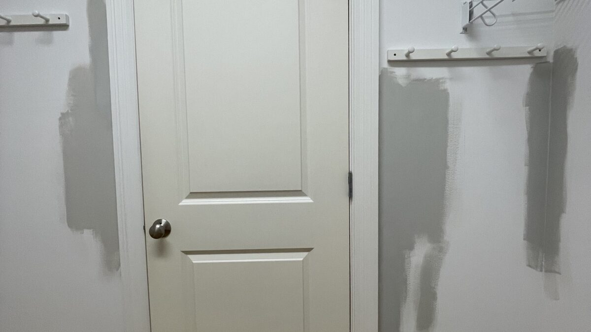 Closet doorway during the makeover with wire shelving coming down and patched walls