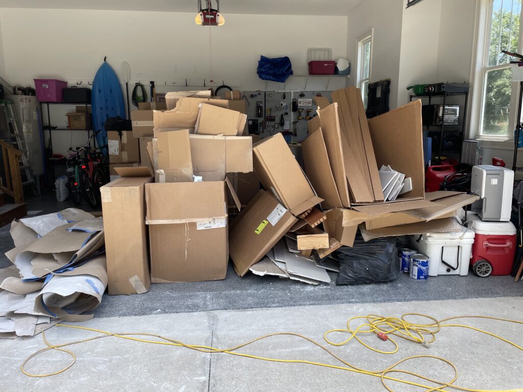 Garage stacked with moving boxes while selling one home and buying another