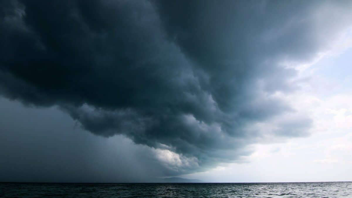 Dark storm clouds over the ocean indicating hurricane risk in Wilmington, NC.