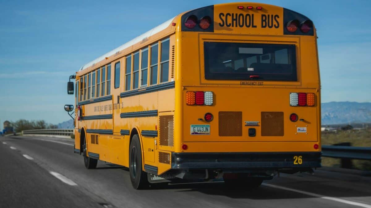 Yellow school bus driving on highway near Wilmington, NC.