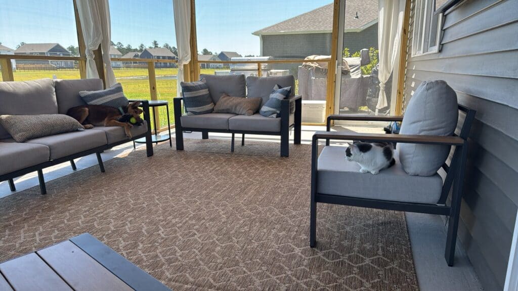 Covered back patio with outdoor seating in a newer Wilmington-area neighborhood