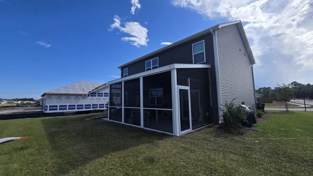 Exterior of a gray two-story Wilmington-area home with a screened back porch
