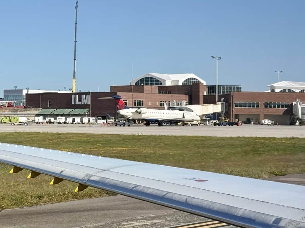 An airplane at the gate at Wilmington International Airport (ILM), the airport serving flights between Wilmington NC and Boston