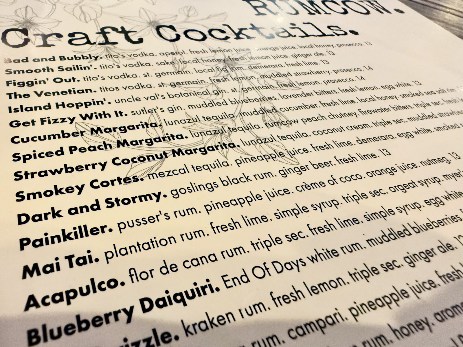 The craft cocktail menu at RumCow in downtown Wilmington NC, featuring the Smokey Cortes with mezcal, pineapple juice and ginger beer
