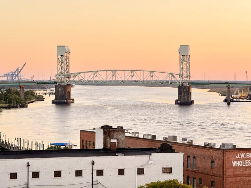The Cape Fear Memorial Bridge over the Cape Fear River at sunset, seen from a rooftop in downtown Wilmington NC